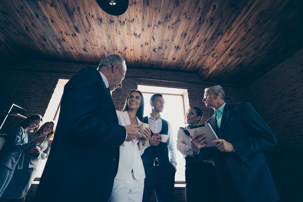 Managers of a large company gather to discuss employer branding efforts.