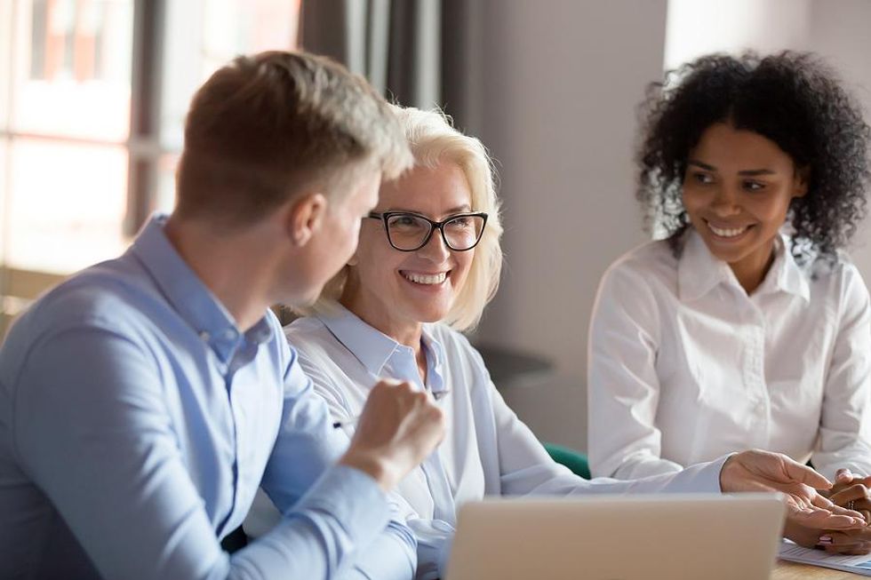 Marketing executive smiles during a meeting