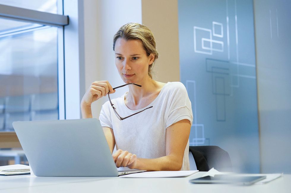 Medical device sales rep does some training on her laptop