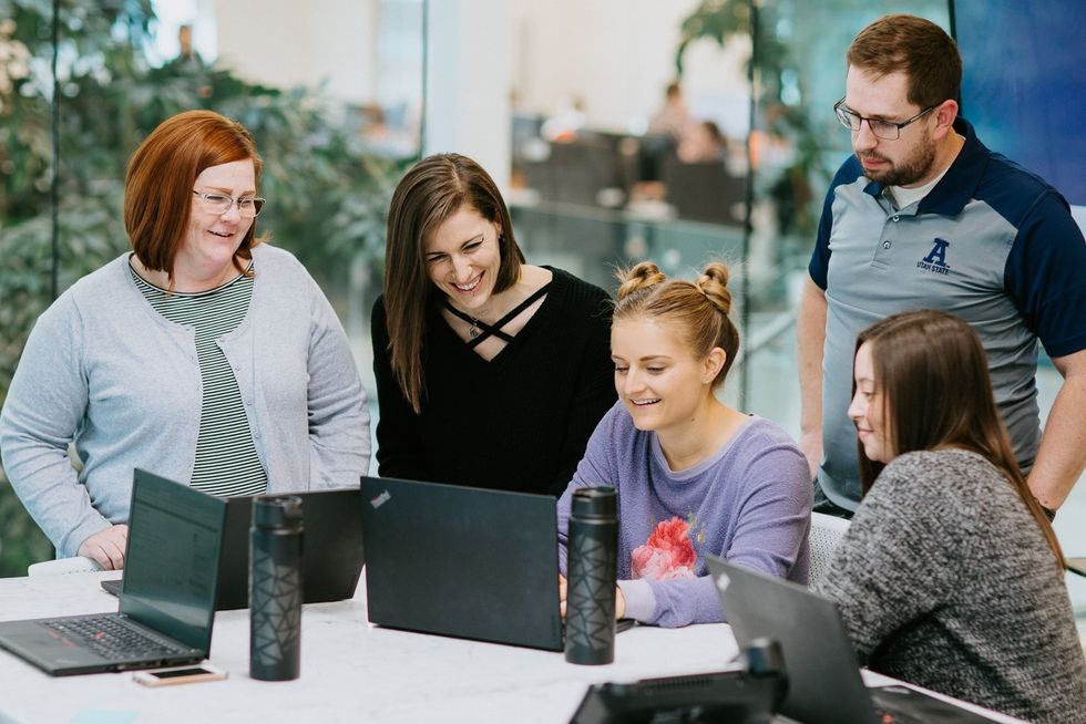 Members of Malouf's reputation team hold a meeting.