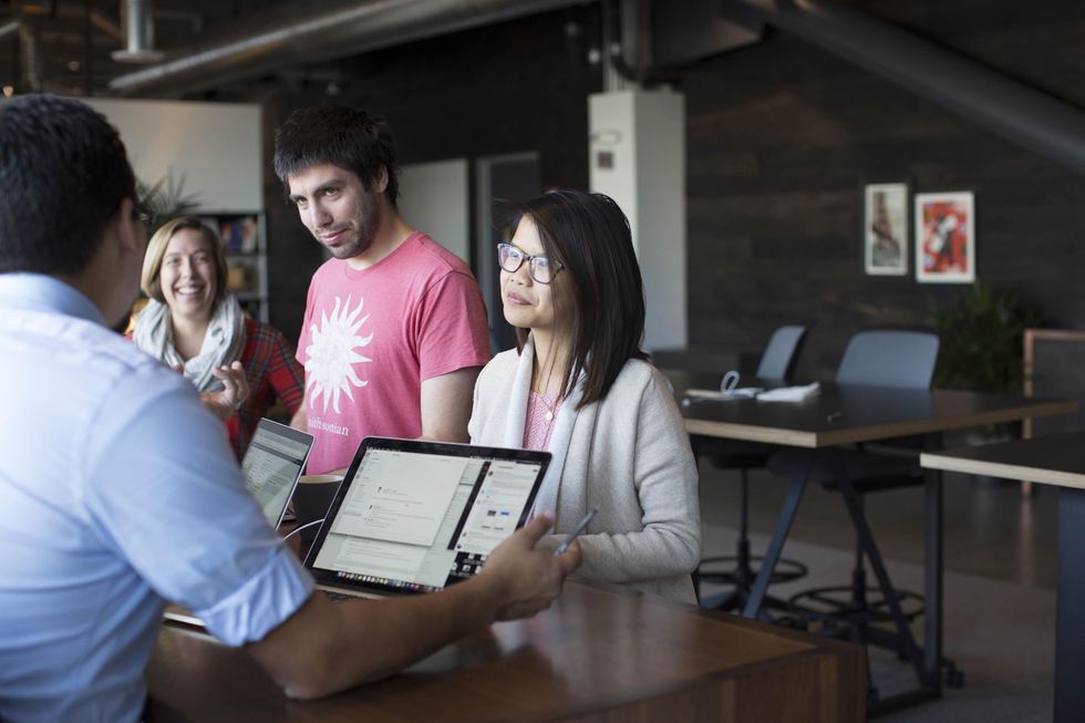 Members of Stripe's Information Technology team collaborate on a project.