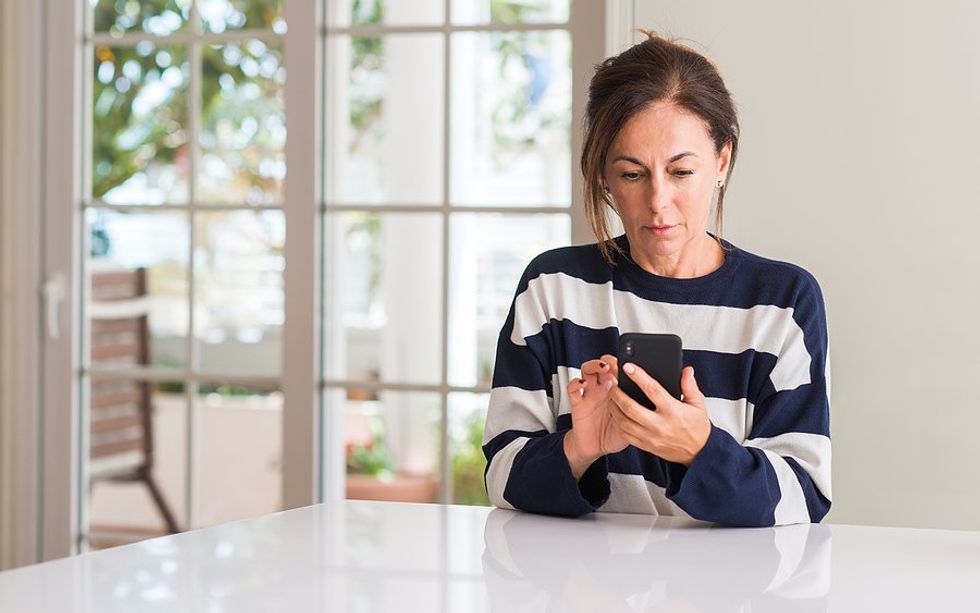 Middle aged woman on phone learns how to market herself correctly in her job search