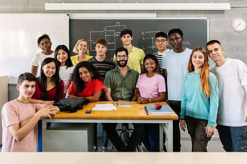 Multilingual students with their teacher in the classroom