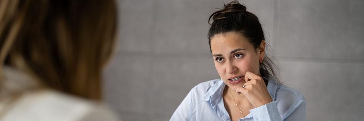 Nervous woman tries to answer a question about rage quitting in her job interview