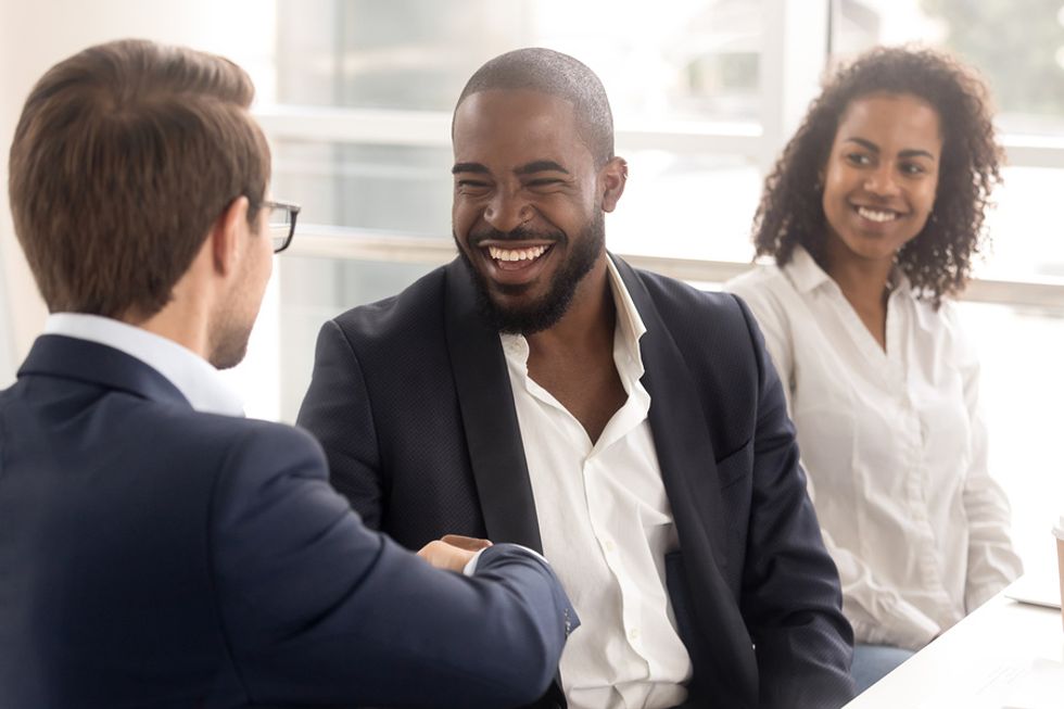 New employee shares a laugh with his boss