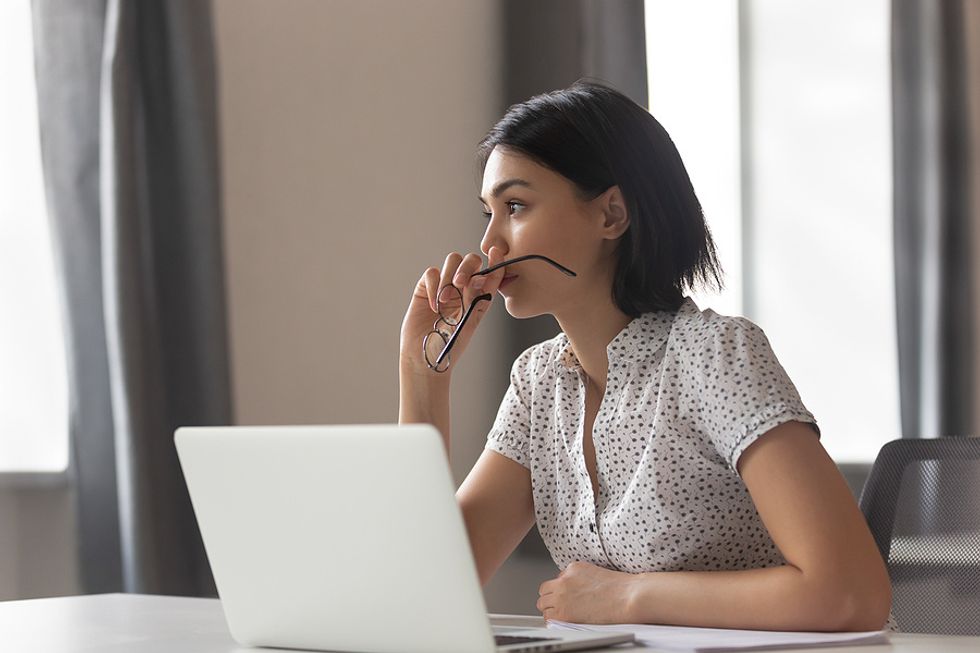 New manager on laptop thinks about her mistakes