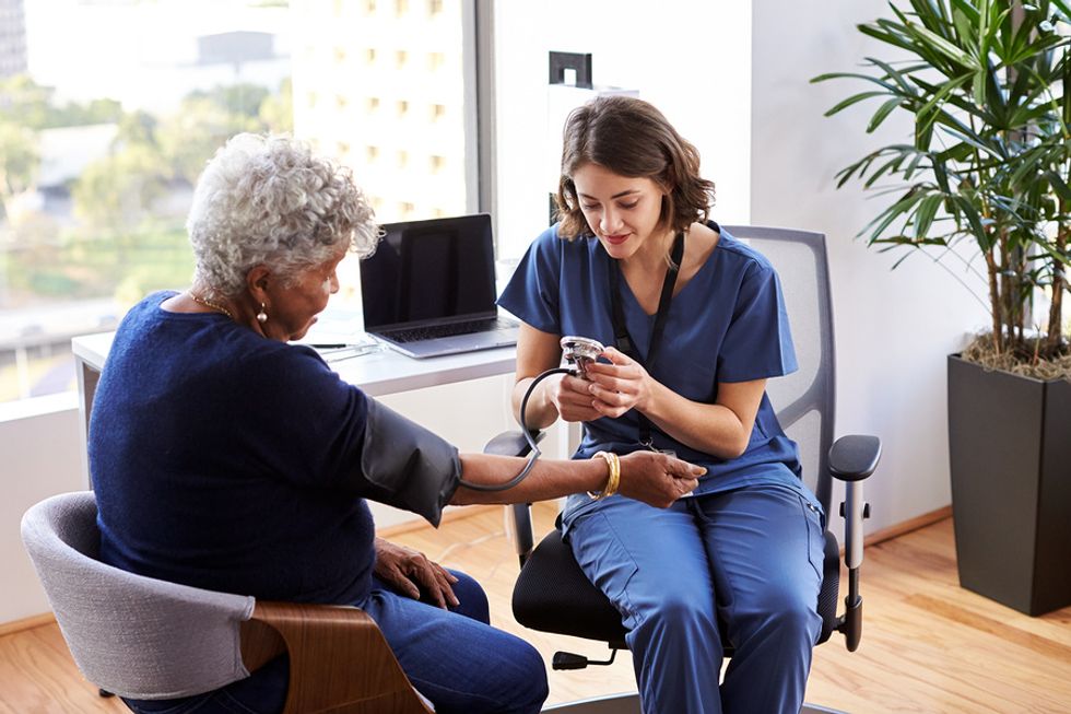 Nurse takes a patient's blood pressure