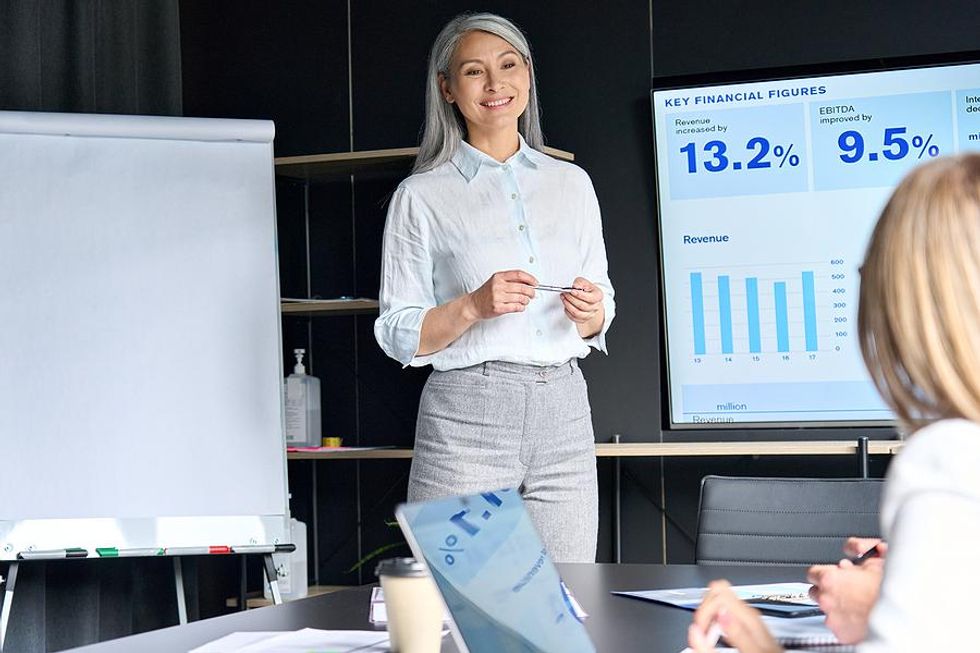 Older professional gives a presentation