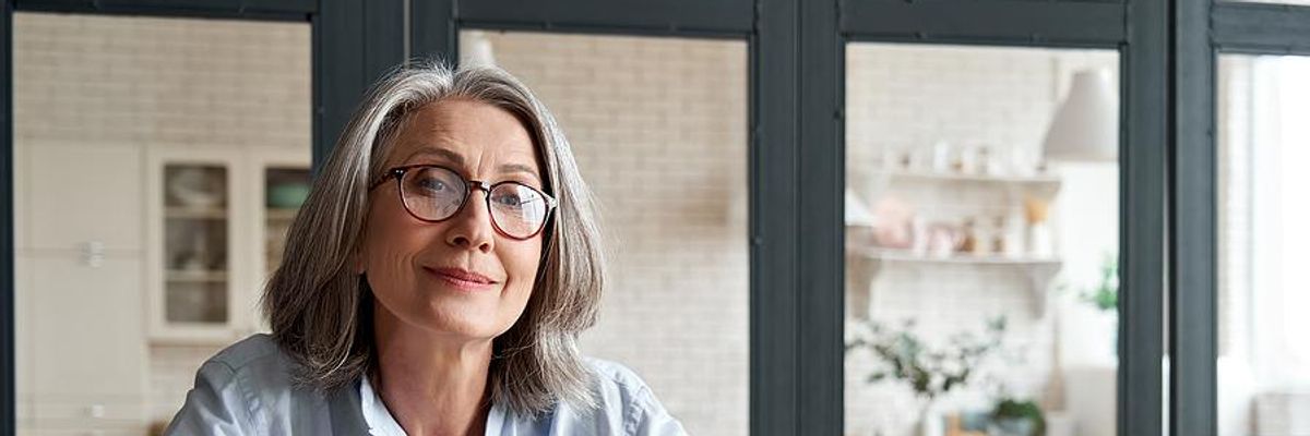 Older professional smiles while taking actions to stay relevant in her career