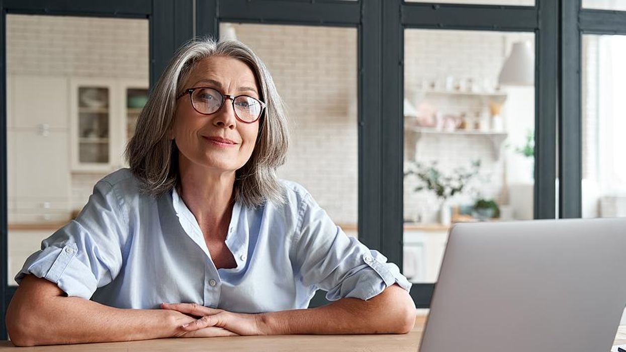 Older professional smiles while taking actions to stay relevant in her career
