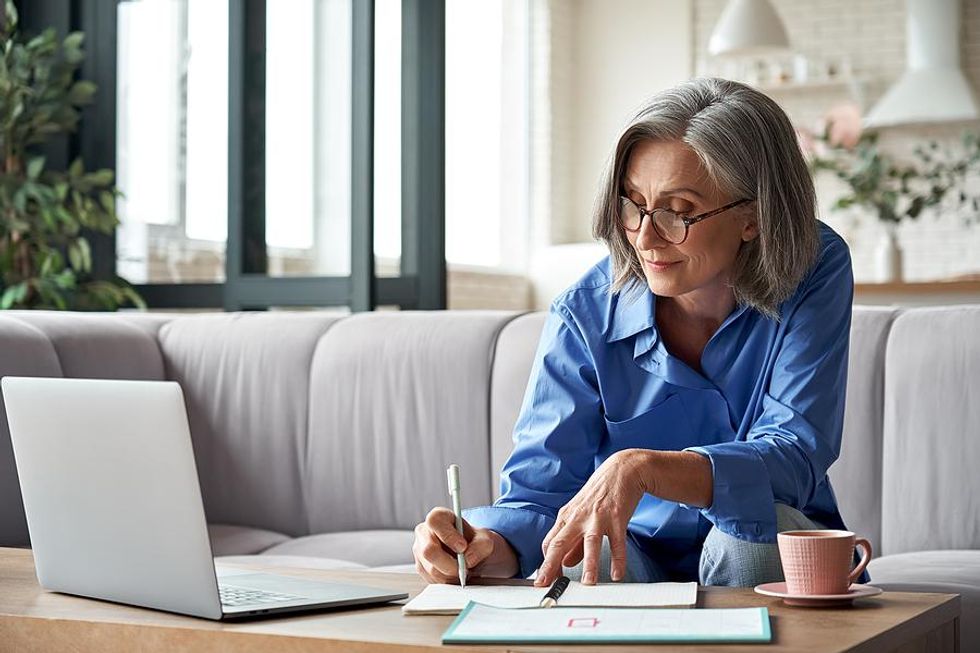 Older woman removes outdated information from her resume