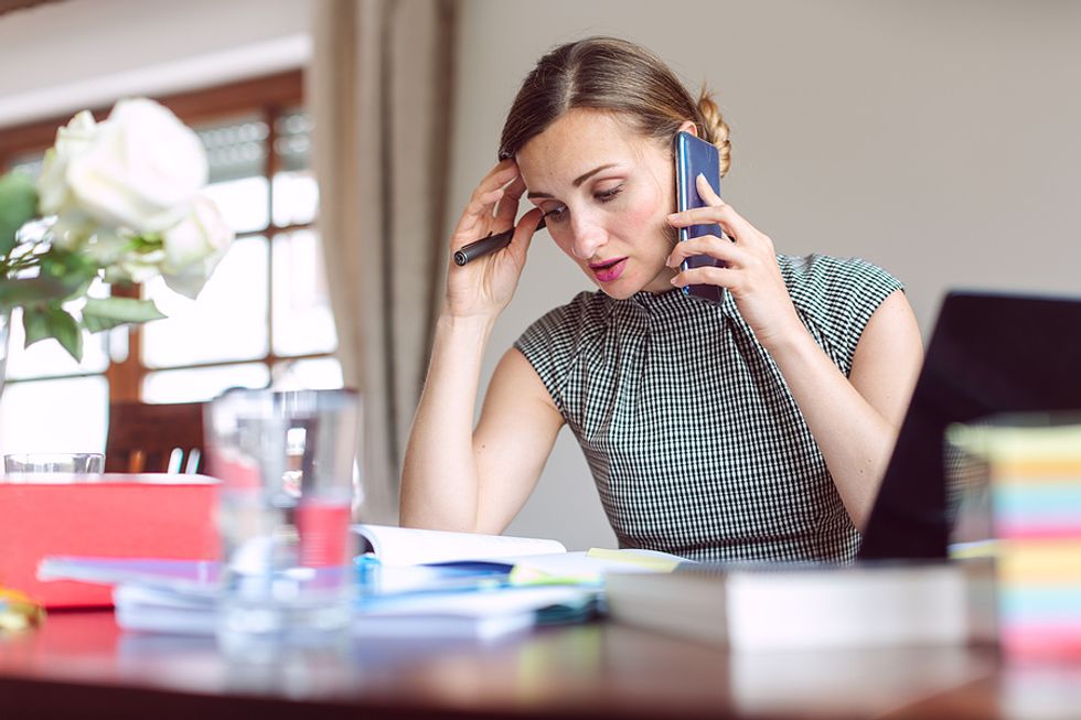 Overworked woman on phone considers quitting her job