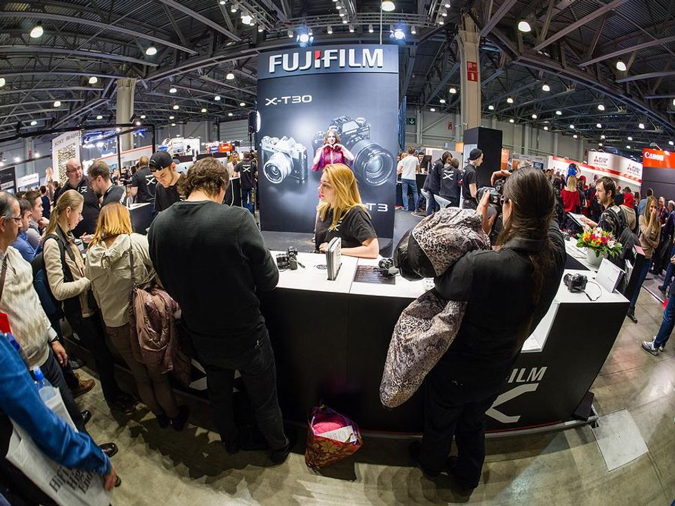 People visit a booth at a tradeshow