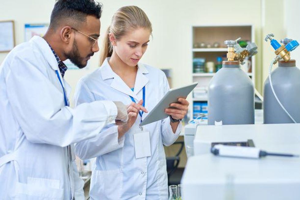 Pharmacy technicians consult over a prescription.