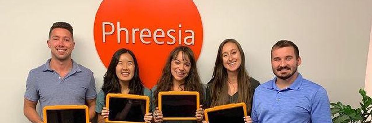 Phreesia client service associates hold the company's patient intake app.