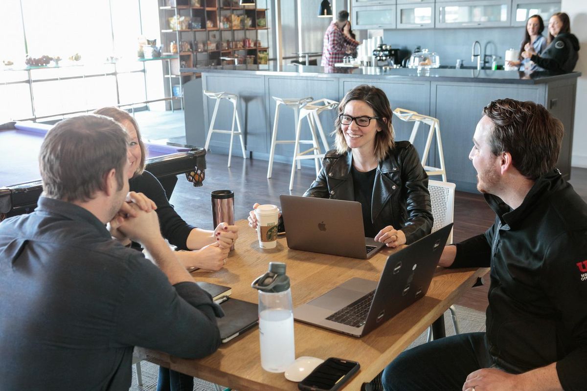 Pluralsight employees collaborate on a project.