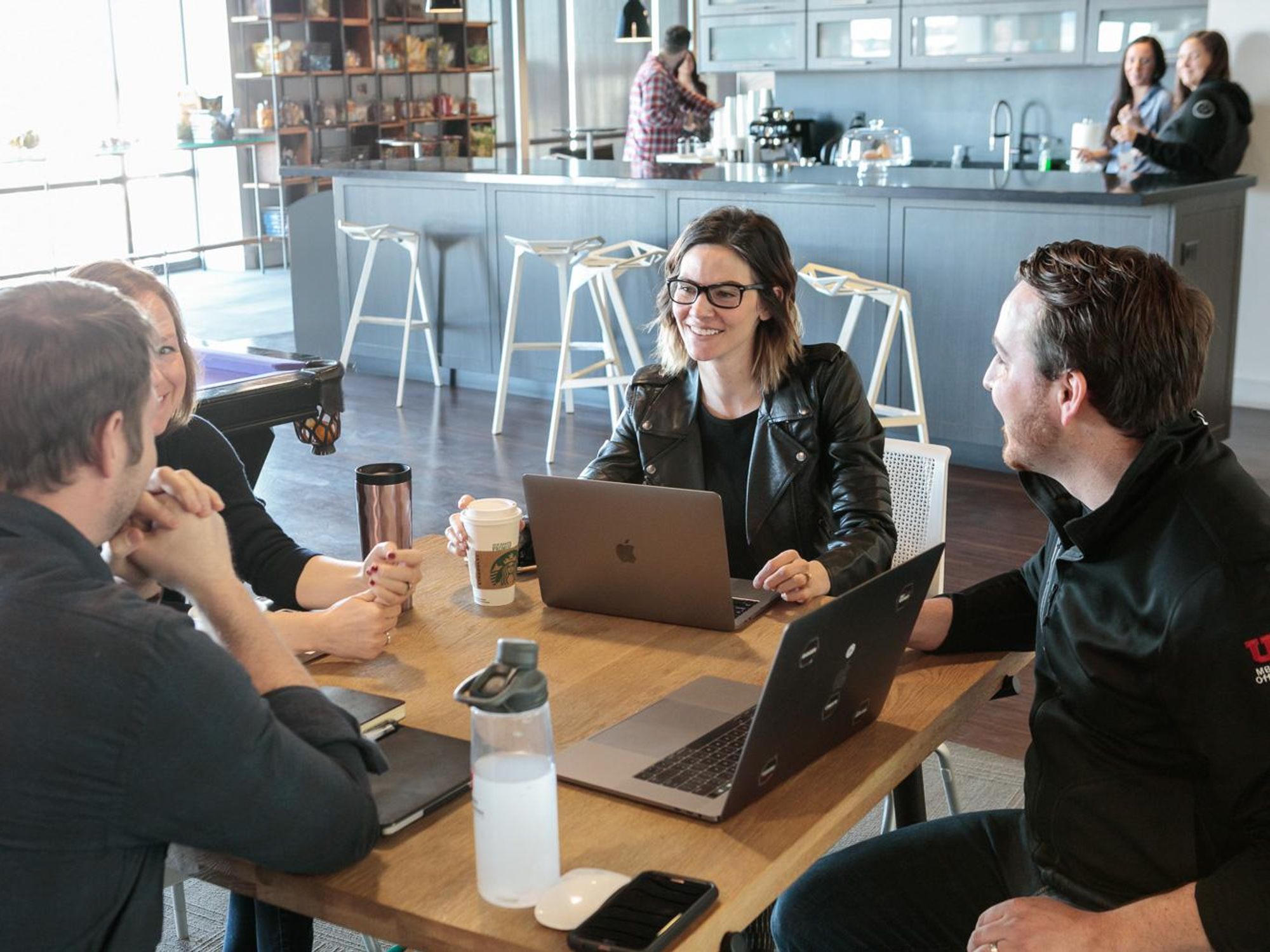 Pluralsight employees collaborate on a project.