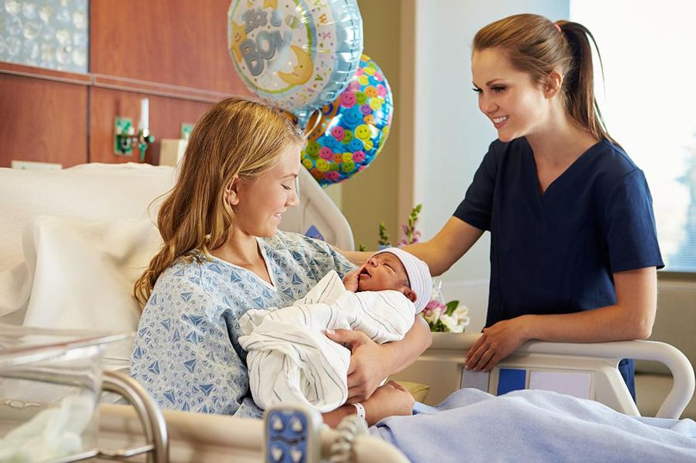 Postpartum nurse helps a new mother
