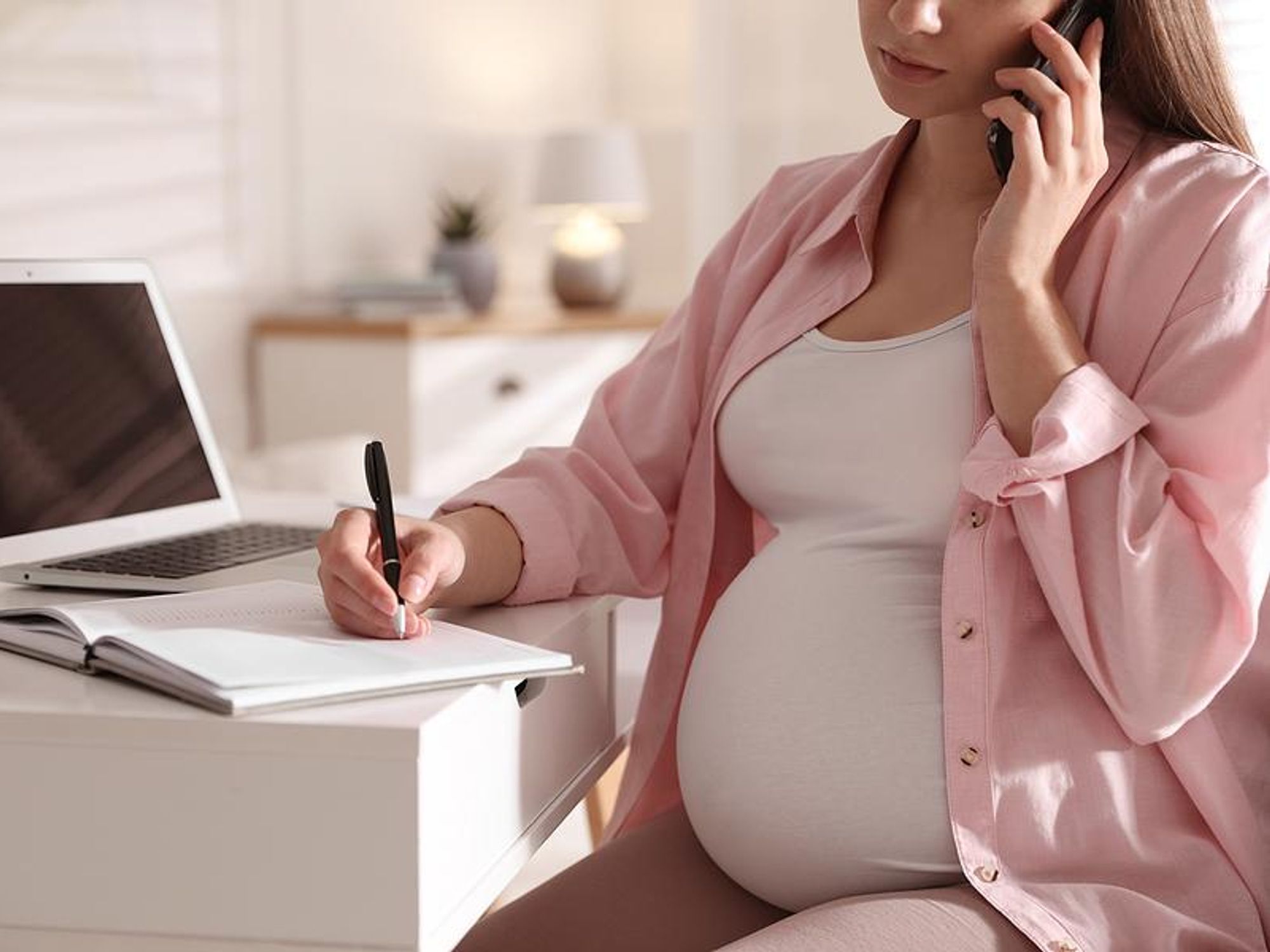 Pregnant woman makes a phone call