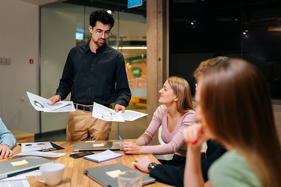 Professional/leader with good professional presence talks during a work meeting