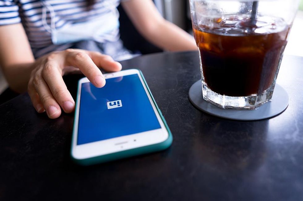 Professional logs in to LinkedIn on their phone