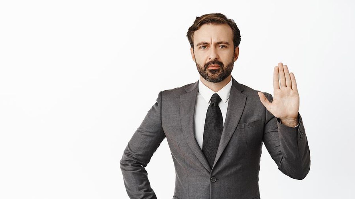 Professional man holds up his hand to tell someone to stop