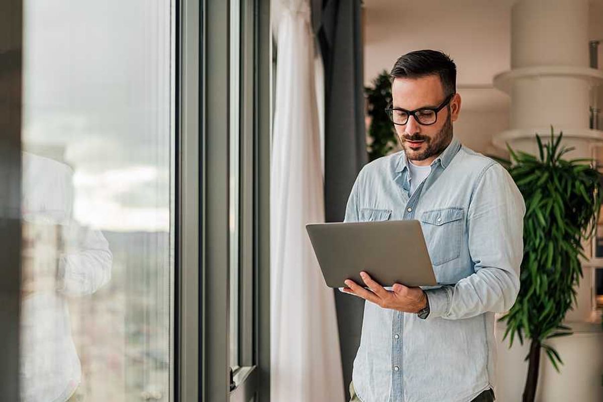 Professional man on laptop uses AI/automation to amplify his professional authority