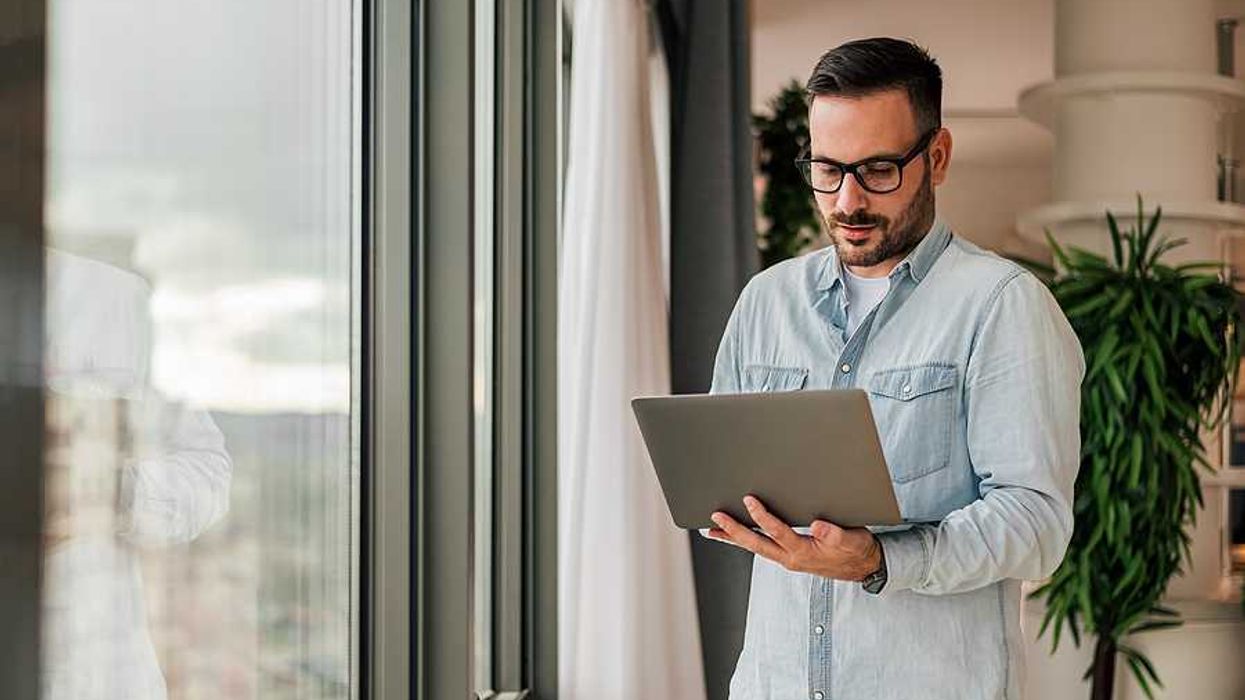 Professional man on laptop uses AI/automation to amplify his professional authority