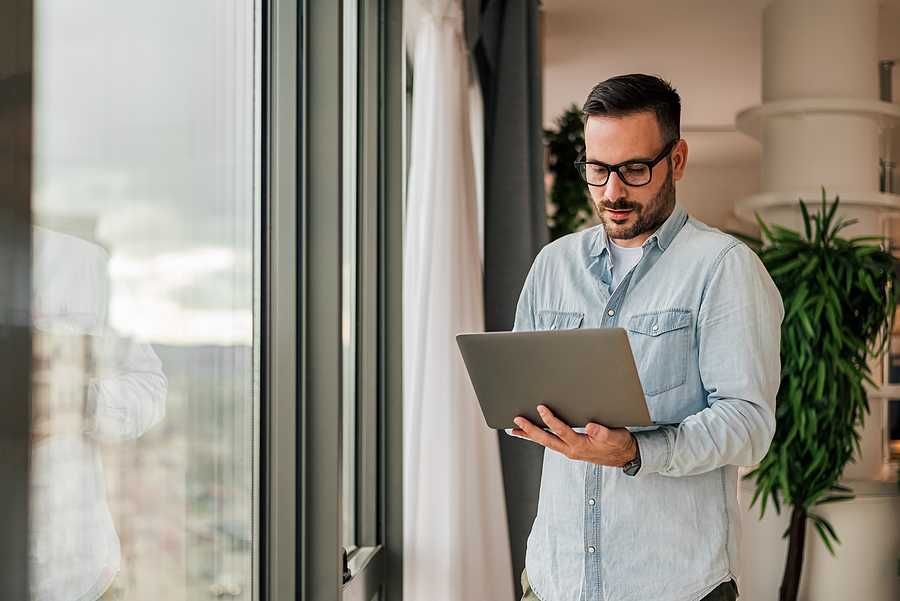 Professional man on laptop uses AI/automation to amplify his professional authority
