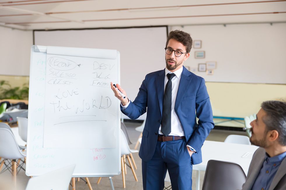 Professional man proves he is an indispensable employee during a work meeting by saving the company money