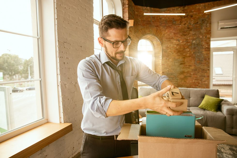 Professional man\ setting up his desk in a new office