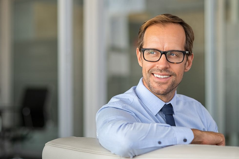 Professional man smiles and recovers after not getting the job