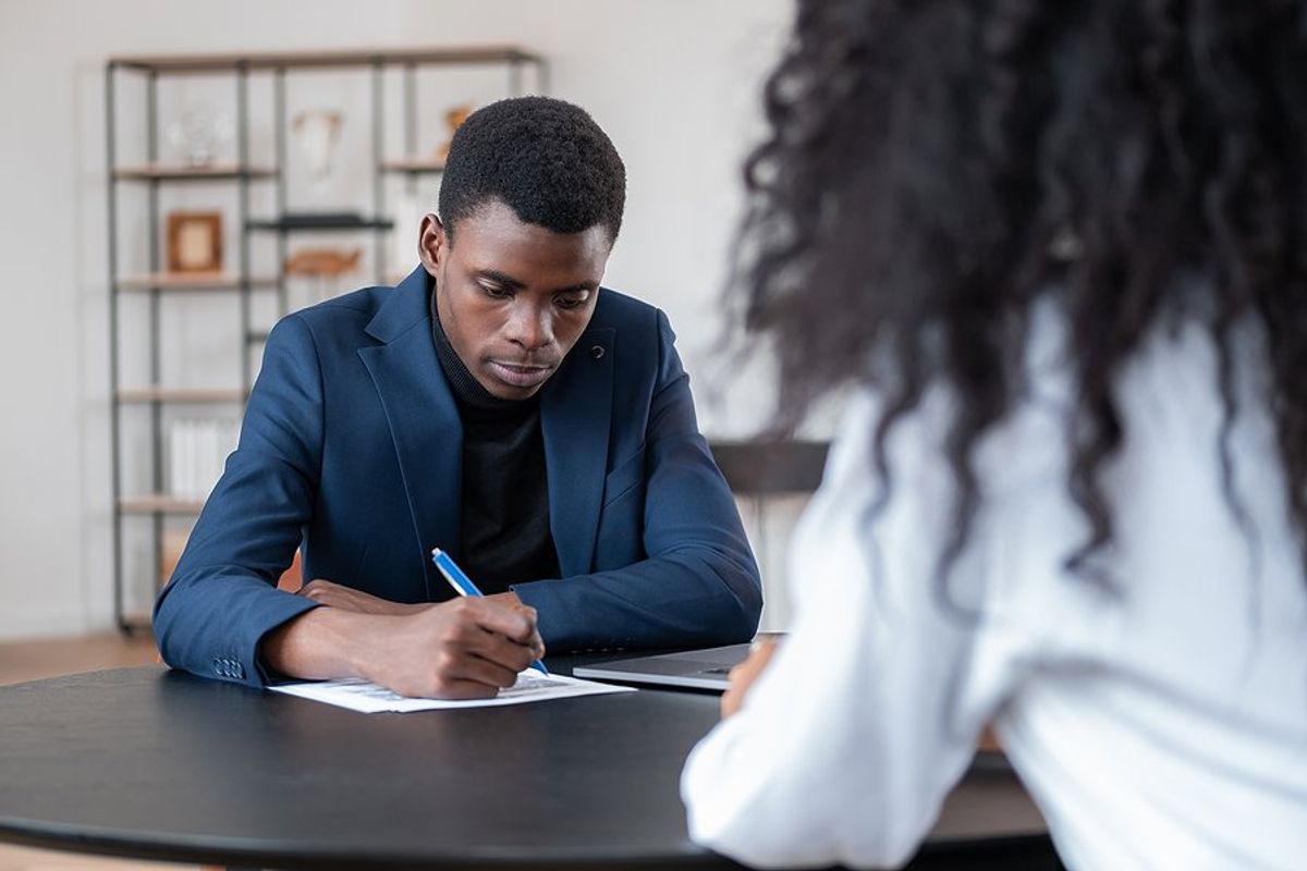 Professional man takes notes during a job interview