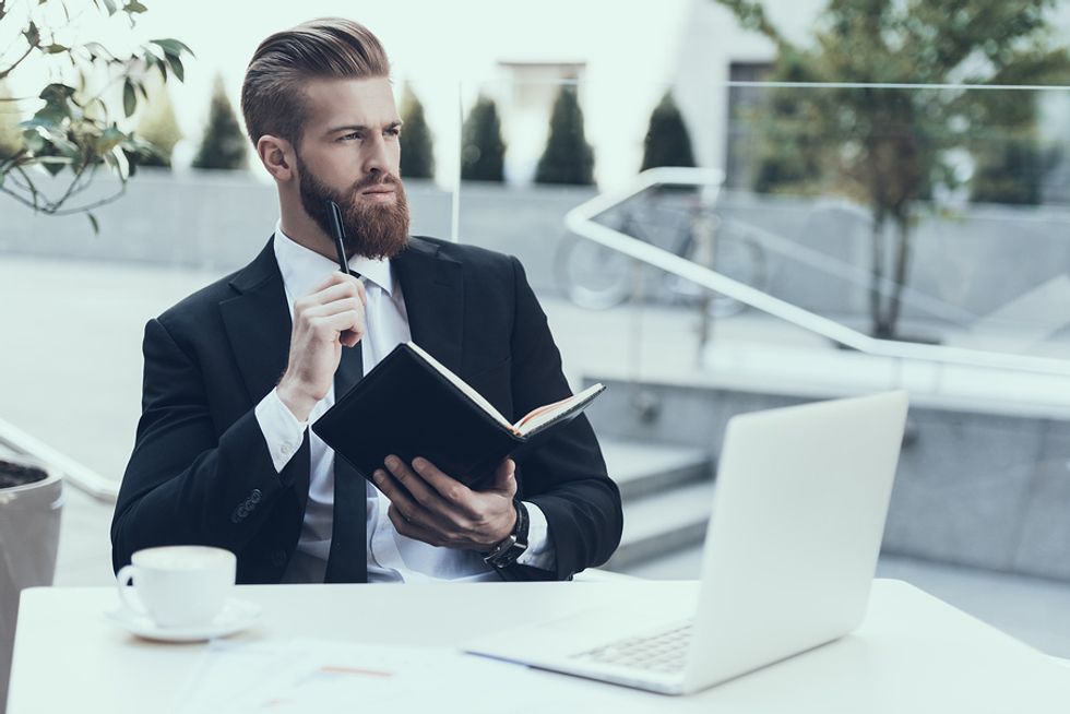 Professional man thinking about his career goals to write a powerful personal branding statement