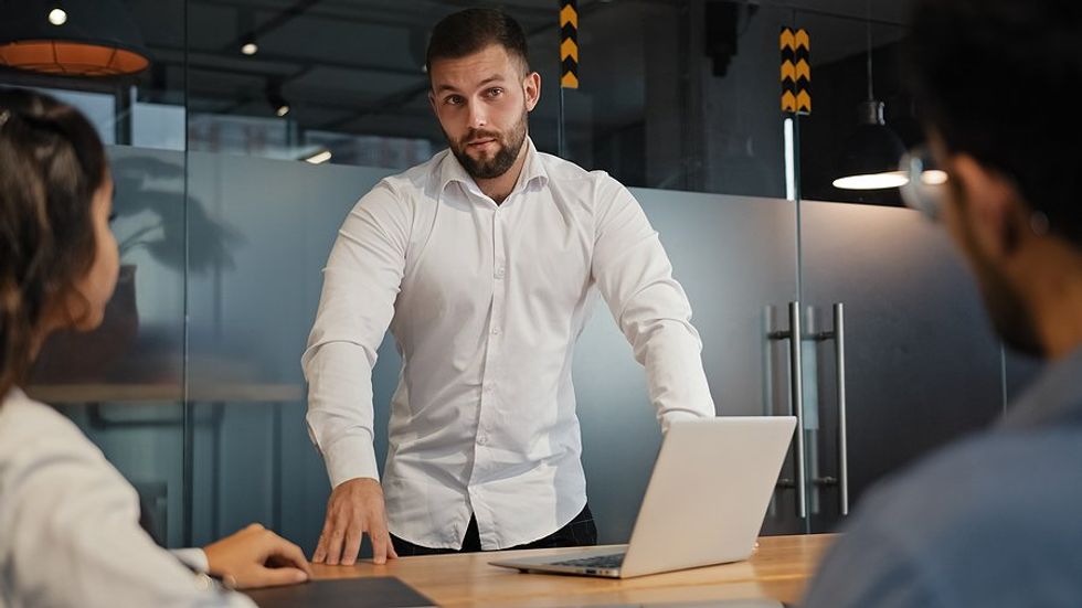 Professional man with good time management skills talks during a work meeting