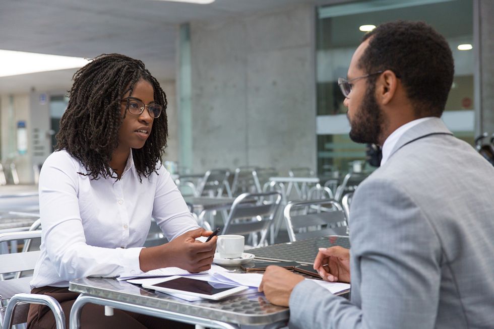 Professional woman being honest with her boss about why she was late