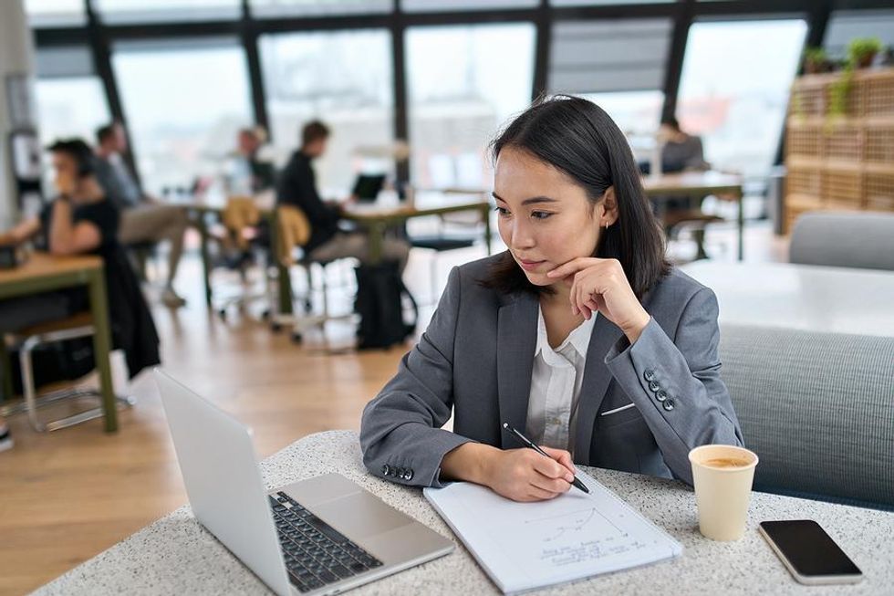 Professional woman learns a new skill while watching a training/webinar