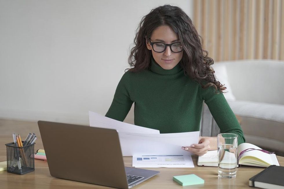 Professional woman looks at documents at work