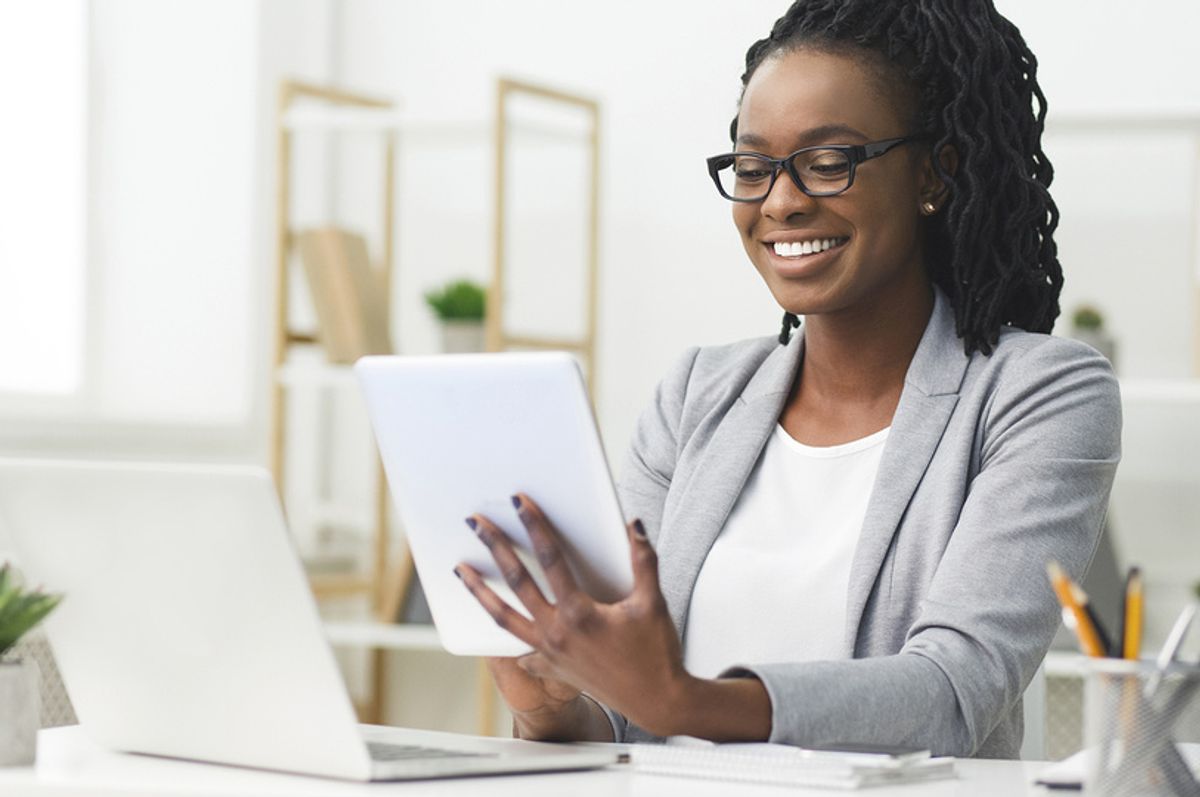Professional woman on laptop and tablet gets started on LinkedIn