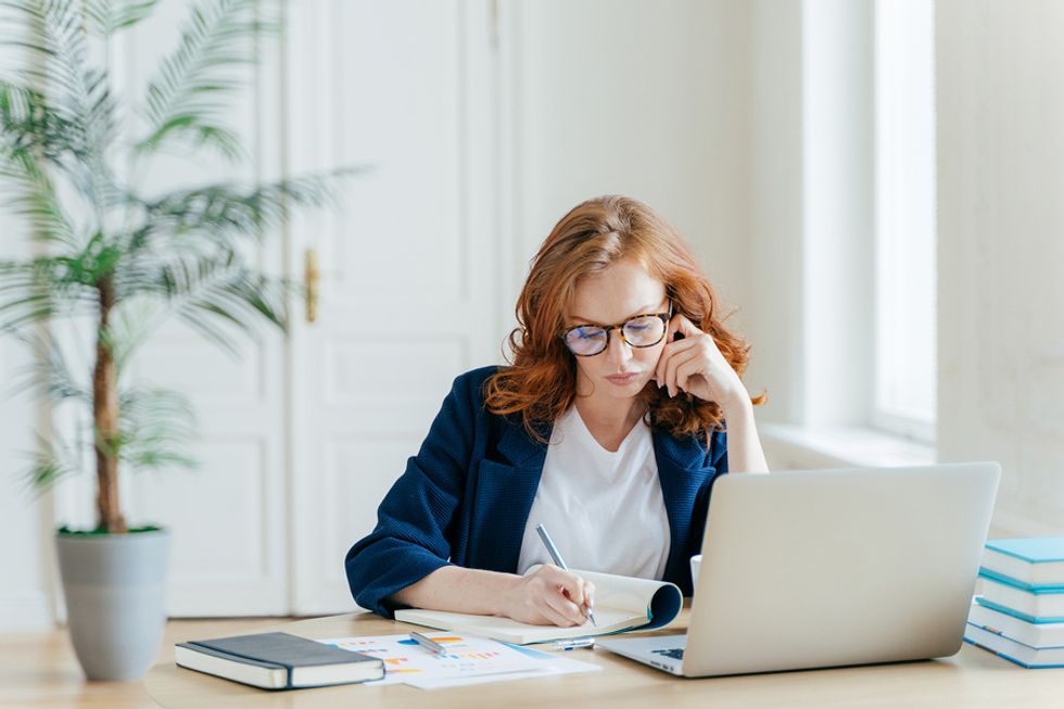 Professional woman on laptop learning how to create a great personal brand