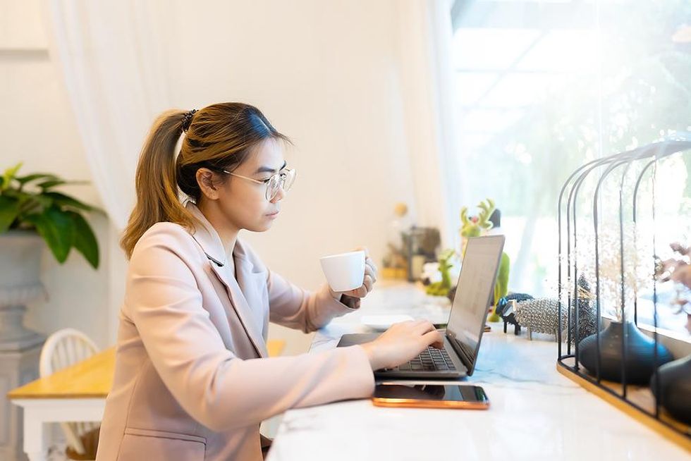 Professional woman on laptop looks for a job