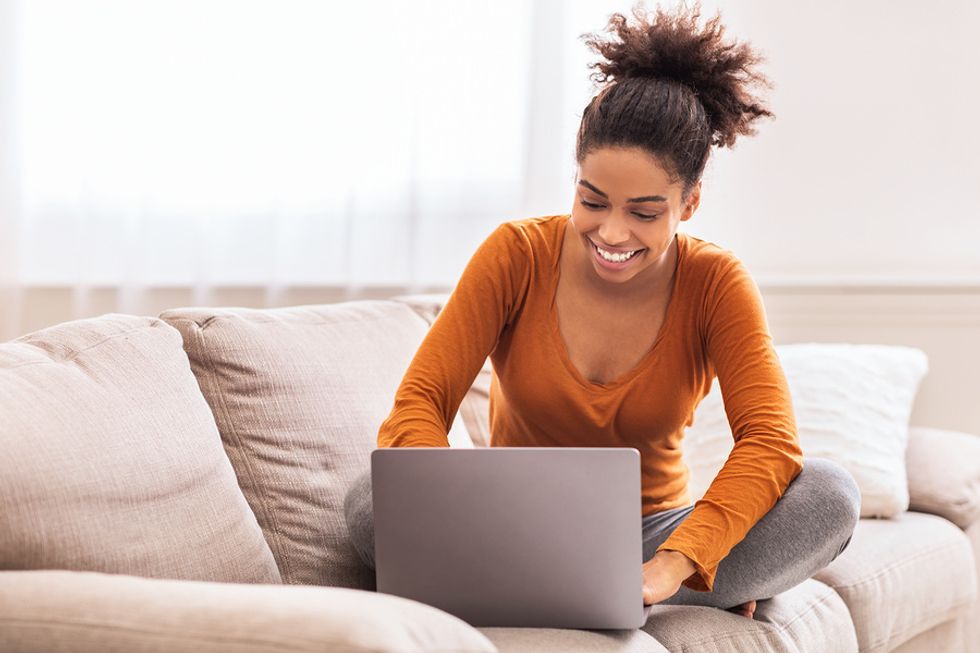 Professional woman on laptop telecommutes for work