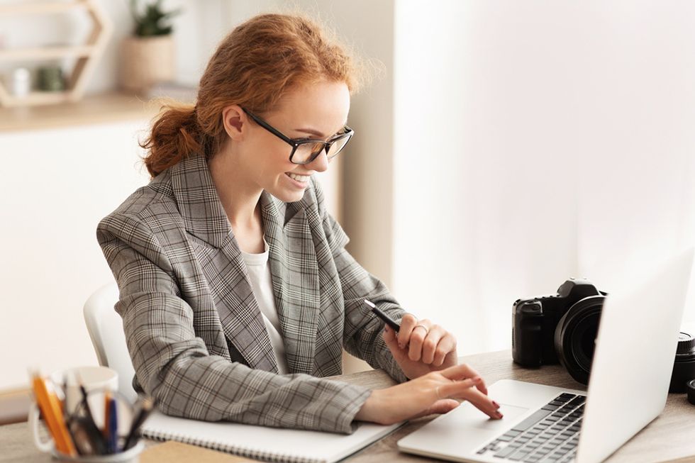Professional woman on laptop writes about outcomes and accomplishments on her resume