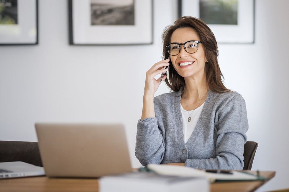 Professional woman on the phone while working from home