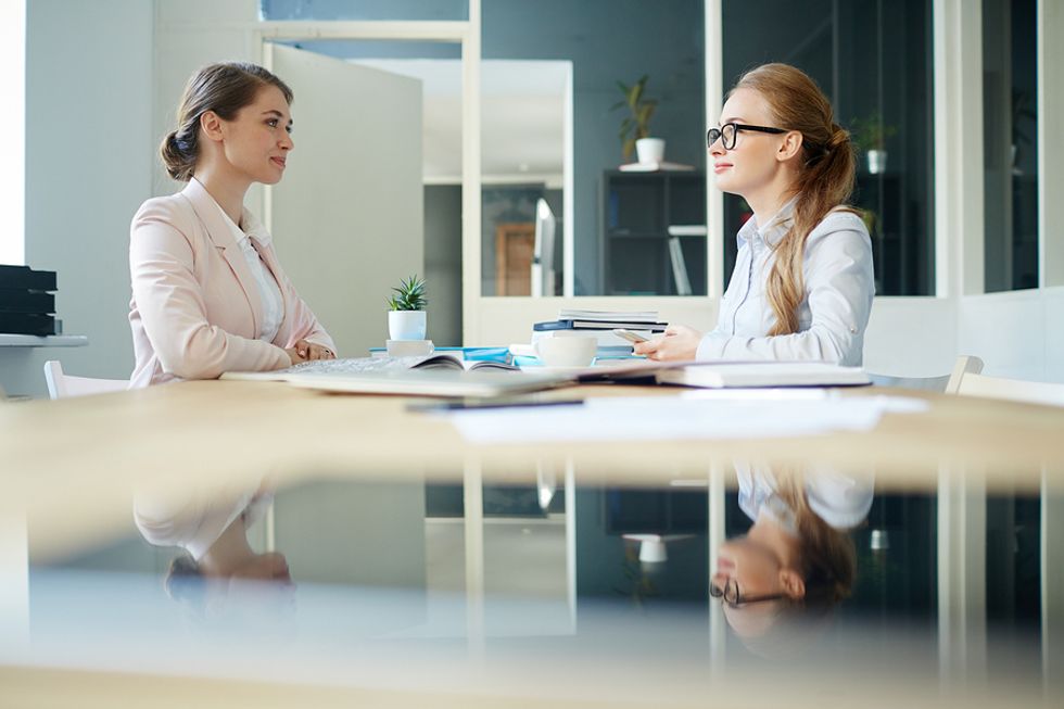 Professional woman practices her answer to the interview question, 