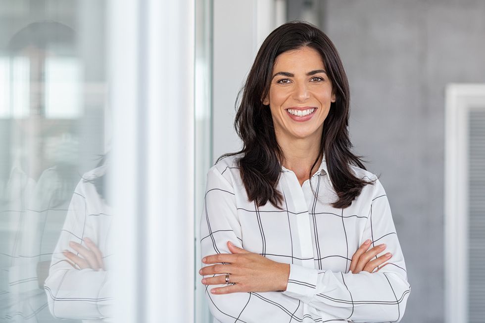 Professional woman smiles and is hopeful after she didn't get the job