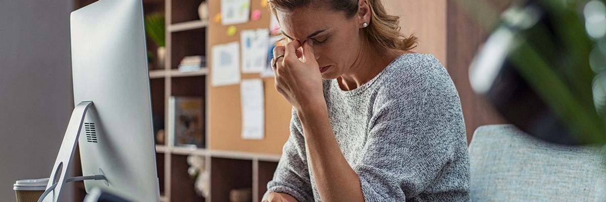 Professional woman stressed out from job at her desk