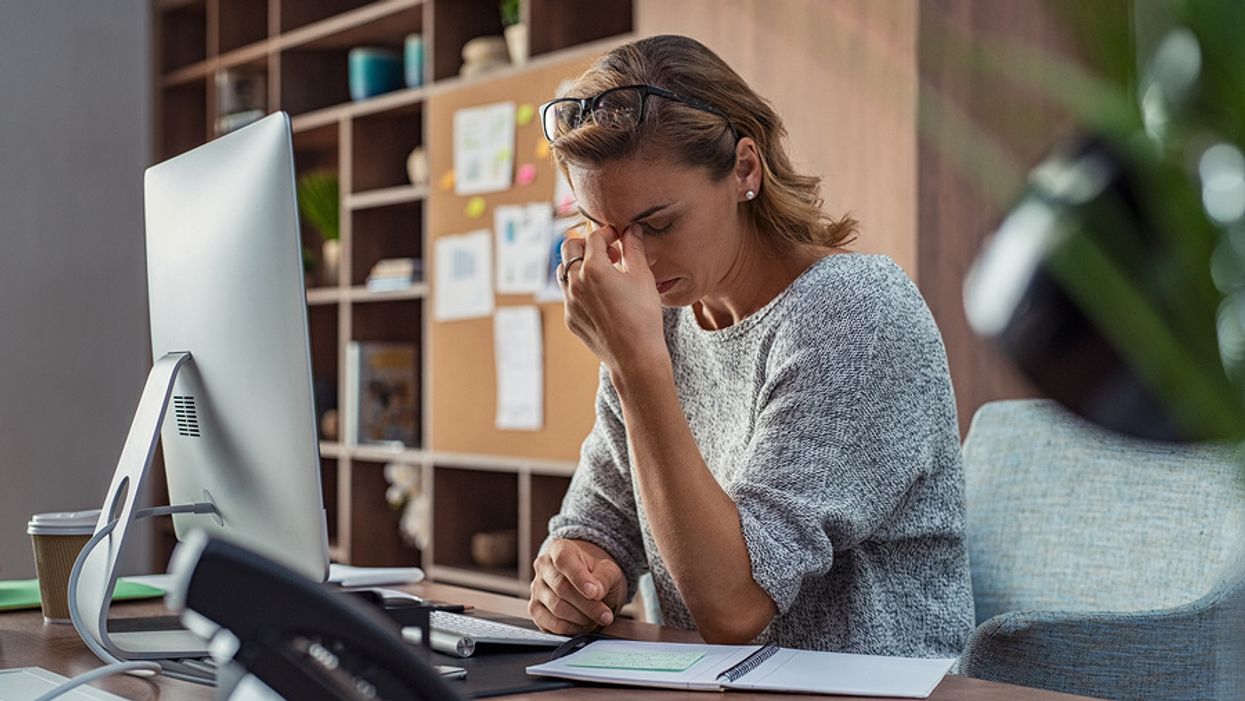 Professional woman stressed out from job at her desk
