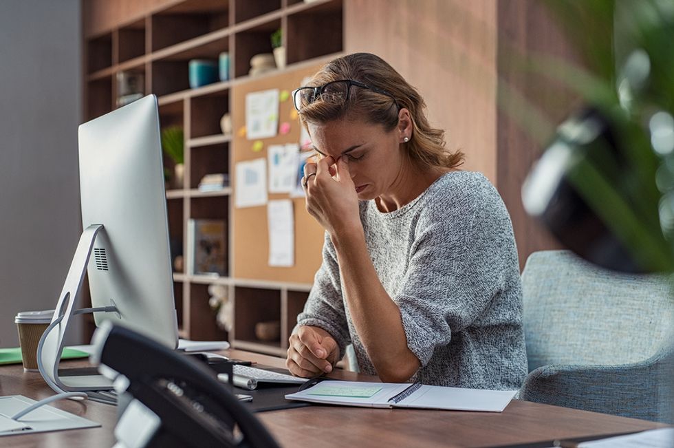Professional woman stressed out from job at her desk