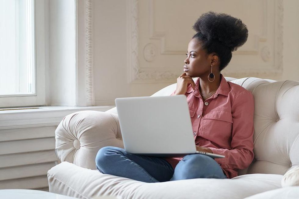 Professional woman with impostor syndrome sits and thinks about her career
